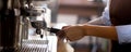 Closeup hands of young asian woman holding coffee grinder powder while mashed for preparing making coffee. Royalty Free Stock Photo