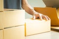 Closeup hands of young man packing boxes. Royalty Free Stock Photo