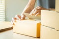 Closeup hands of young man packing boxes. Royalty Free Stock Photo