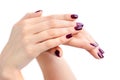 Closeup of hands of a young woman with dark red manicure on nails against white background Royalty Free Stock Photo