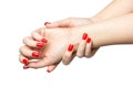 Closeup of hands a young woman with long red nails manicure on white background Royalty Free Stock Photo