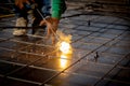 Closeup hands young worker using machine welding iron with hands working in industrial factory. Royalty Free Stock Photo