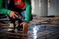 Closeup hands young worker using machine welding iron with hands working in industrial factory. Royalty Free Stock Photo