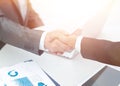 Closeup .handshake of business partners above the Desk