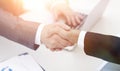 Closeup .handshake of business partners above the Desk