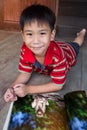 Closeup handsome asian boy smiling and reading picture album. Ed