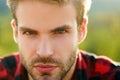 Closeup of handsome man portrait. Bearded hipster, serious emotions, gay guy.