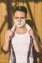 Closeup of handsome man with shaving foam on his face and towel Royalty Free Stock Photo