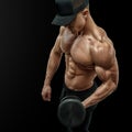 Closeup of a handsome power athletic man bodybuilder doing exercises with dumbbell in left hand Royalty Free Stock Photo