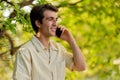 Closeup of handsome young man talking on phone at park Royalty Free Stock Photo
