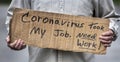 Closeup handwritten cardboard sign, Coronavirus Took My Job, man`s hands, unemployed, downsized, job