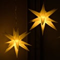 Closeup of hanging illuminated kringle moravian paper stars - Christmas concept