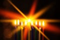 Closeup of Hanukkah menorah, or hanukkiah for Jewish holiday Hanukkah. Nine colored candles.