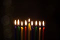 Closeup of Hanukkah menorah, or hanukkiah for Jewish holiday Hanukkah. Nine colored candles.