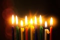 Closeup of Hanukkah menorah, or hanukkiah for Jewish holiday Hanukkah. Nine colored candles.