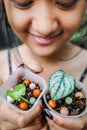 Happy Beautiful Exotic Asian Teen Girl Holding Tiny Tropical Leaves