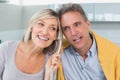 Closeup of a happy couple using telephone in kitchen Royalty Free Stock Photo