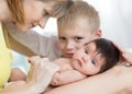 Closeup of happy family. Joyful mom, her kid son and newborn baby together Royalty Free Stock Photo