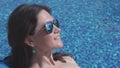 Closeup of happy female face in sunglasses, woman suntanning