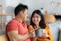 Closeup of happy loving asian couple drinking tea together Royalty Free Stock Photo