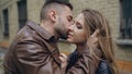 Closeup of happy loving couple kissing and embracing while havinhg walk in city street Royalty Free Stock Photo