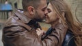 Closeup of happy loving couple kissing and embracing while havinhg walk in city street Royalty Free Stock Photo