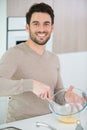 closeup happy man whisking eggs in bowl Royalty Free Stock Photo