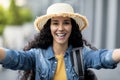 Closeup of happy pretty woman tourist taking selfie