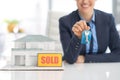 Closeup on happy realtor woman showing keys