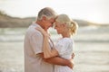 Closeup of a happy senior caucasian couple standing and embracing each other on a day out at the beach. Mature husband Royalty Free Stock Photo
