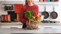 Closeup on happy young housewife with local market purchases in Royalty Free Stock Photo