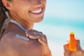 Closeup on happy young woman applying sun block creme Royalty Free Stock Photo