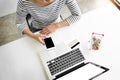 Closeup of happy young woman holding credit card inputting card Royalty Free Stock Photo