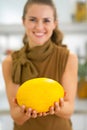 Closeup on happy young woman showing melon Royalty Free Stock Photo