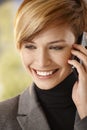 Closeup of happy young woman talking on mobile Royalty Free Stock Photo