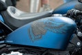 Closeup of Harley Davidson logo on blue motorbike tank of Harley Davidson motorbike parked in the street Royalty Free Stock Photo