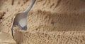 Closeup hazelnut praline ice cream scooping with spoon