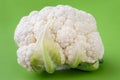 Closeup of head of cauliflower on a green cutting board Royalty Free Stock Photo