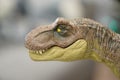 Closeup of the head of a Mattel brand Tyrannosaurus Rex toy figure from the Jurassic World series
