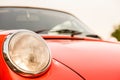 Closeup of the headlight of an old red classic car Royalty Free Stock Photo