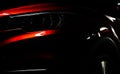 Closeup headlight of shiny red luxury SUV compact car. Elegant electric car technology and business concept. Hybrid auto Royalty Free Stock Photo