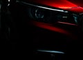 Closeup headlight of shiny red luxury SUV compact car. Elegant electric car technology and business concept. Hybrid auto Royalty Free Stock Photo