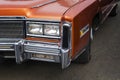 A closeup of the headlights and front bumper on a vintage American automobile. Polished shiny car on a retro exhibition 60-70 year Royalty Free Stock Photo