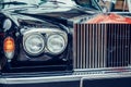 A closeup of the headlights and front bumper on a vintage automobile. Royalty Free Stock Photo