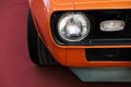 Closeup headlights of an orange retro car. Royalty Free Stock Photo