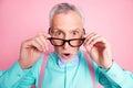 Closeup headshot photo of amazed surprised senior man taking off spectacles with opened mouth isolated on pink color