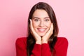 Closeup headshot photo portrait of cute pretty young girl touching cheeks with both hands smiling wearing red sweater Royalty Free Stock Photo