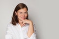 Closeup headshot portrait of friendly cheerful smiling confident female against grey studio wall banner background