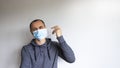 Closeup headshot portrait petrified young handsome man in a grey wear, wearing a protective medicine mask, isolated on beautiful Royalty Free Stock Photo