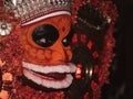 a closeup headshot portrait of a theyyam artist